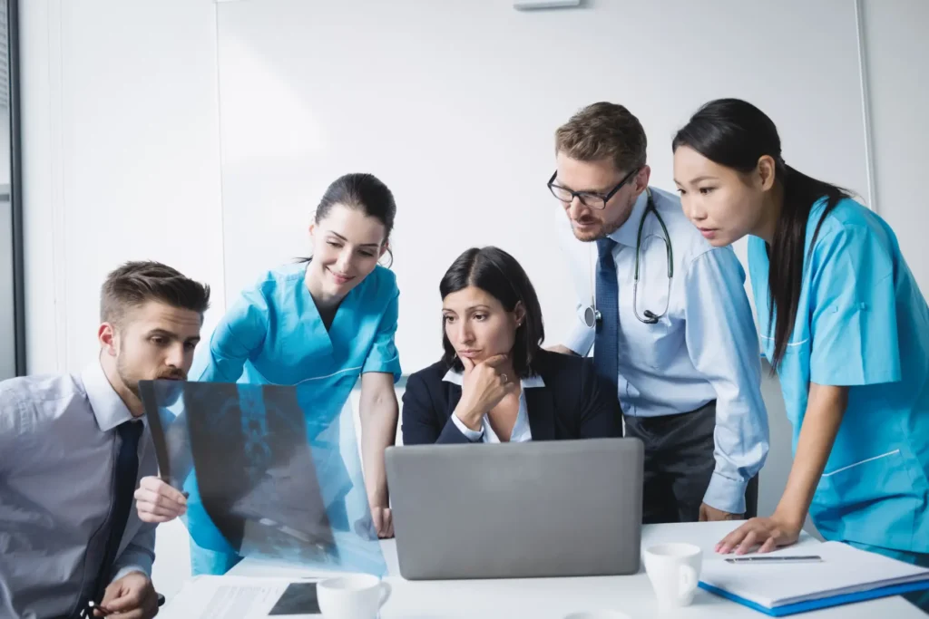 five-medical-professionals-watching-on-laptop-screen